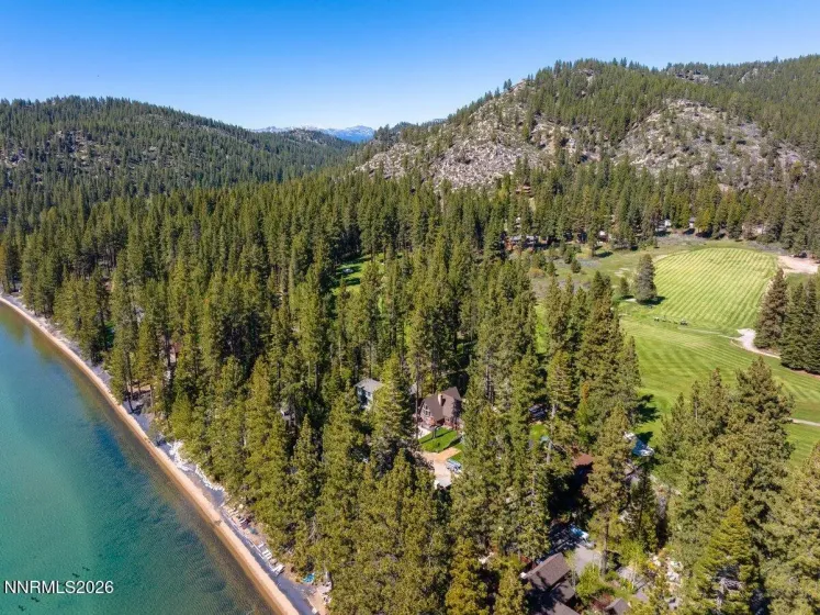 Aerial showing home located between golf course and lake