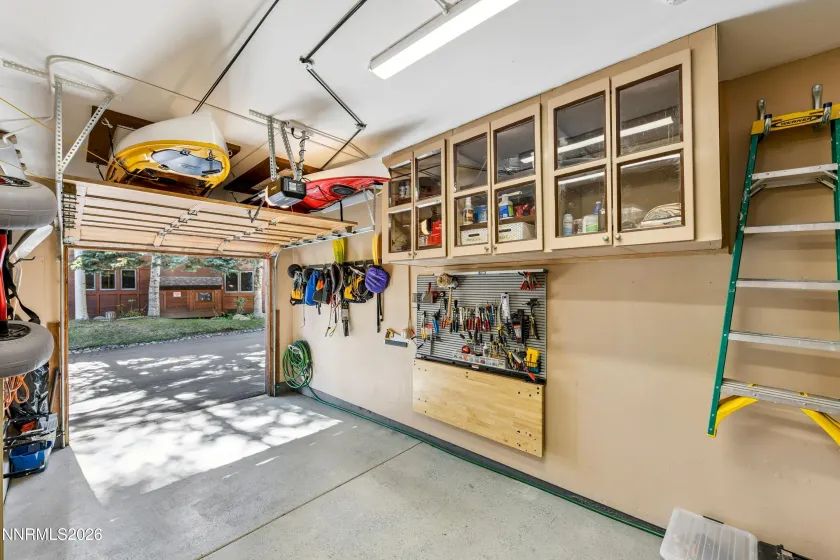 Garage with Storage Cabinets and Lift Up Workbench