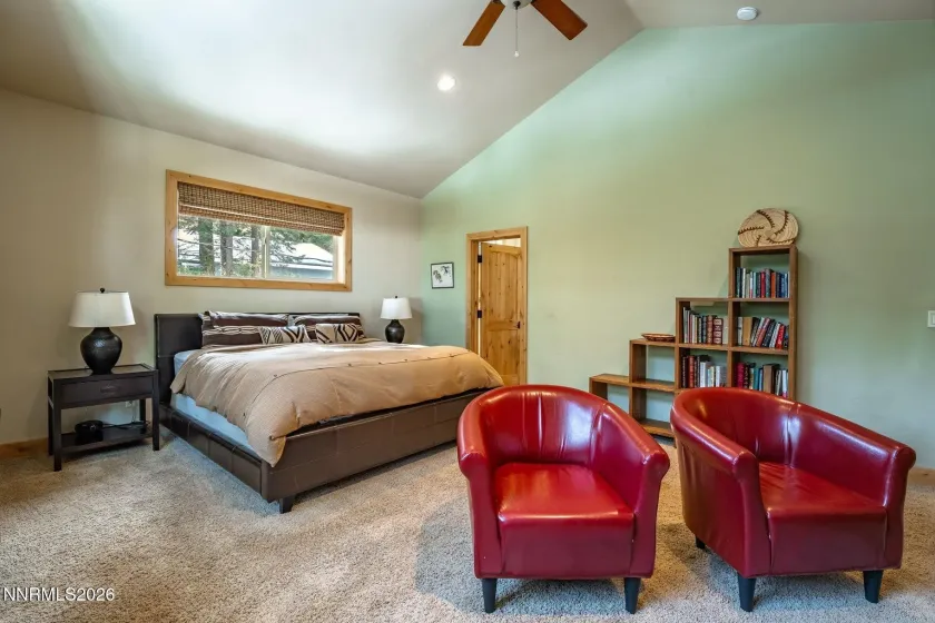 Spacious primary bedroom offering a peaceful setting and cozy sitting area.