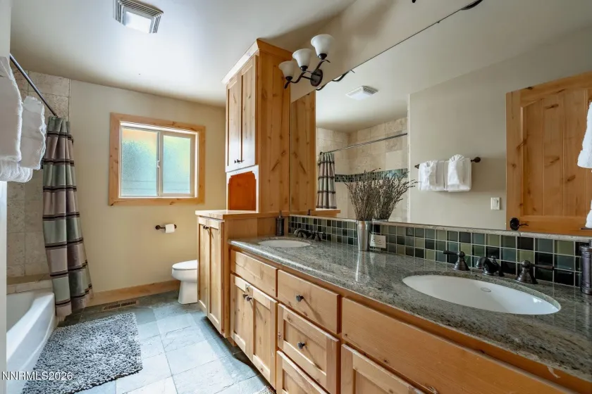 Spacious bathroom with dual-sink vanity and ample counter space.
