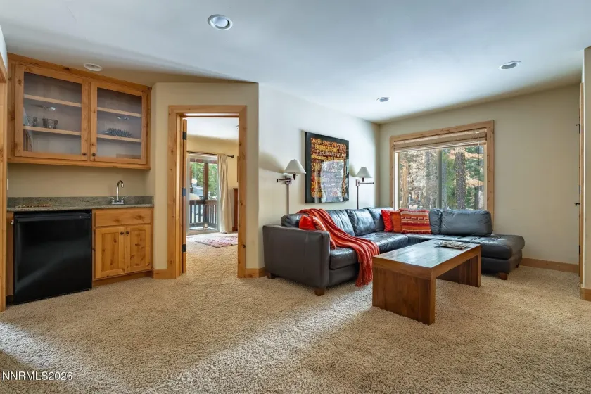 Versatile family room with wet bar access and abundant natural light.