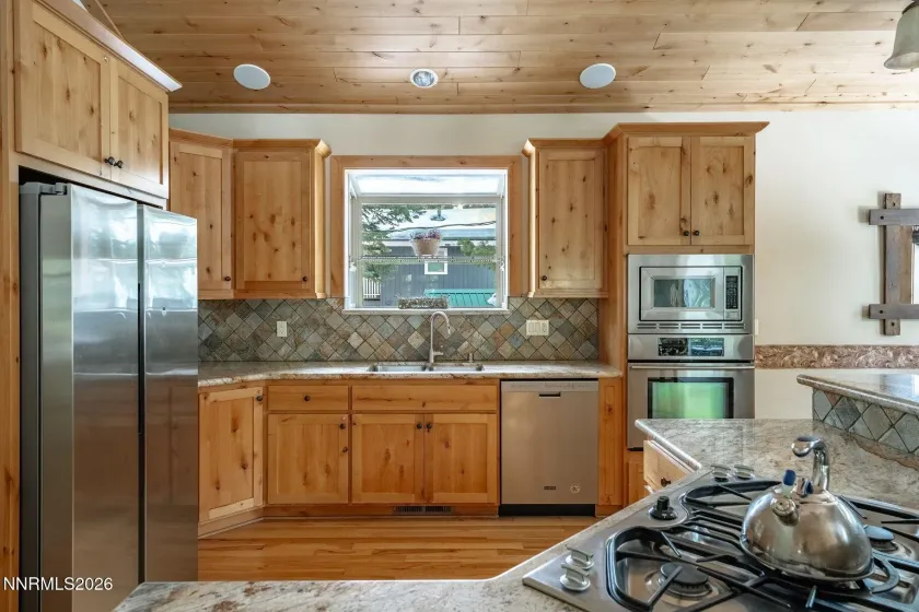 Chef's kitchen featuring stainless steel appliances, granite counters, and ample storage.