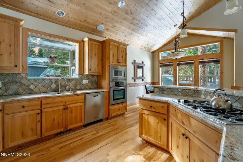 Chef's kitchen with custom wood cabinetry, large center island, and generous workspace.