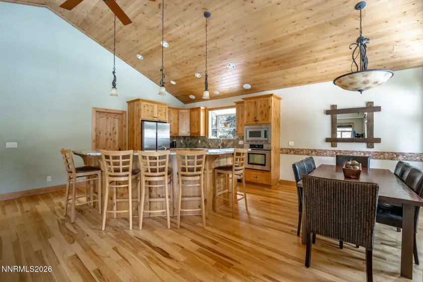 Open-concept kitchen and dining area with vaulted ceilings and generous gathering space.