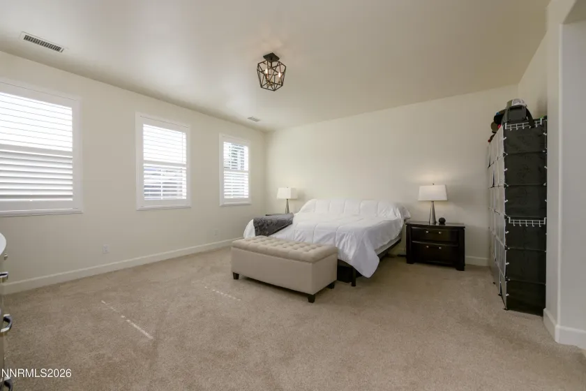Oversized primary bedroom w/ custom shutters