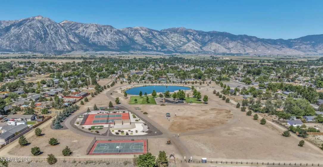 Mitch park ariel. Walking trails, bike pump track, play set, walking trails, basketball and pickle ball courts