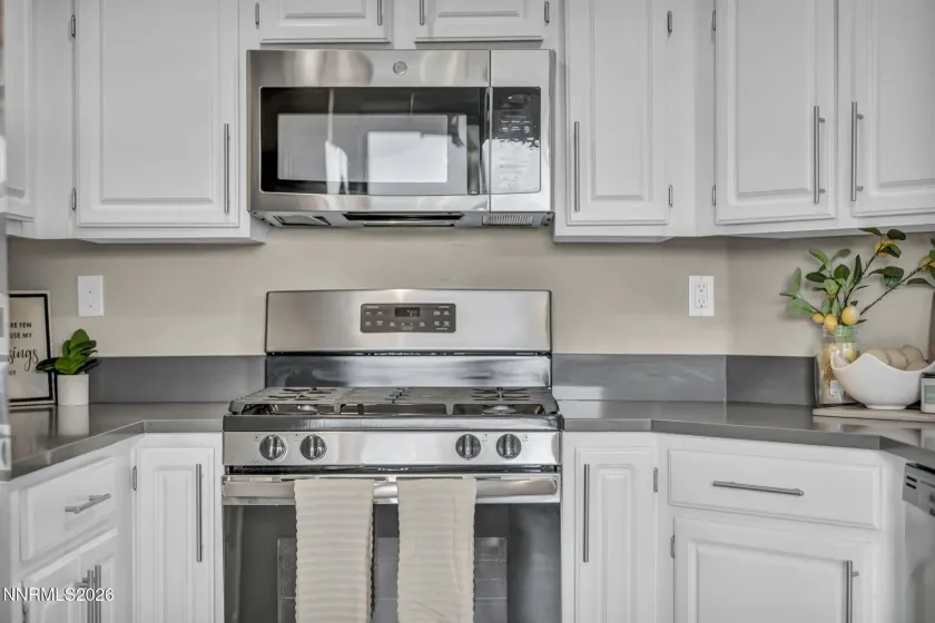 Kitchen Details – Close-up view of the stove, cabinetry, and generous counter space, highlighting the functional design and thoughtful kitchen layout.