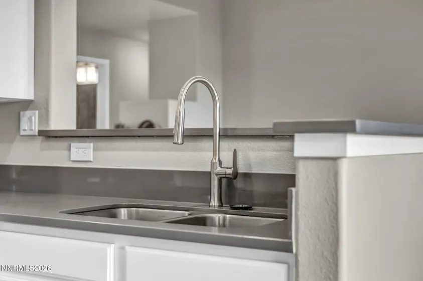 Updated Kitchen Sink & Faucet – Close-up view of the updated sink and modern faucet, highlighting the stylish finishes and functional kitchen features.