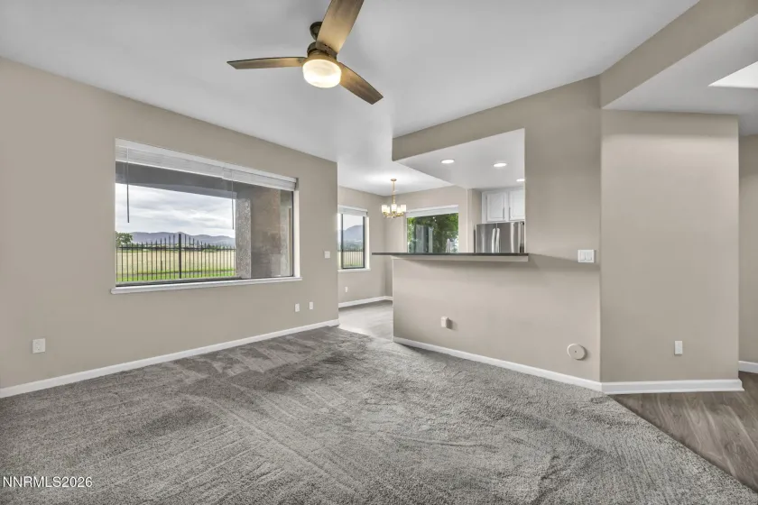 Living Room Corner View – Alternate angle from the living room showcasing the beautiful views through the window, breakfast bar, and kitchen nook, highlighting the open and inviting layout.