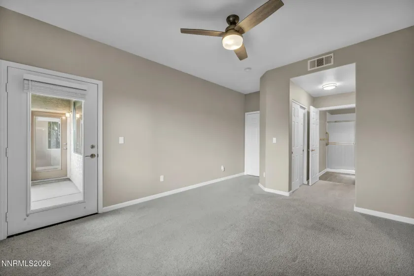 Primary Bedroom – Spacious primary bedroom featuring convenient access to the patio and direct entrance to the en suite bathroom, creating a comfortable and connected retreat.