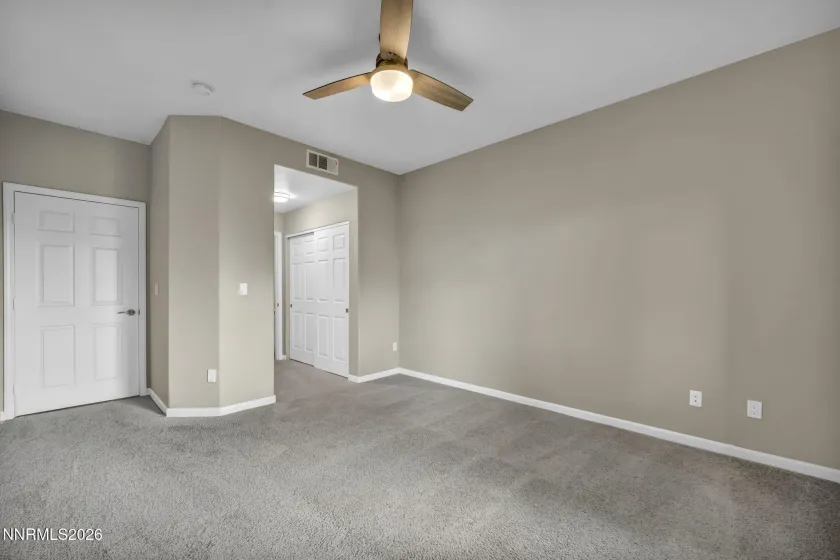 Primary Bedroom View – Alternate angle of the primary bedroom showcasing the entrance to the en suite bathroom.