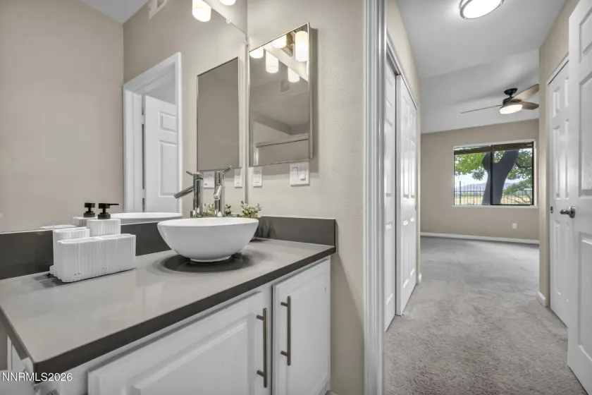 Primary Bathroom – View from the primary bathroom into the adjoining primary bedroom, showcasing the convenient en suite layout.