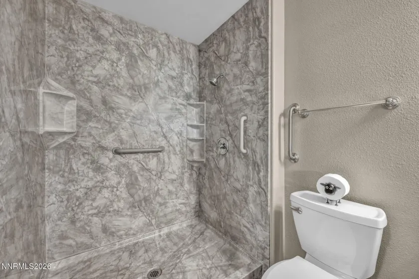 Remodeled Secondary Bathroom – Beautifully remodeled secondary bathroom featuring stylish tile finishes, updated fixtures, and handicap-accessible grab bars for added comfort and convenience.