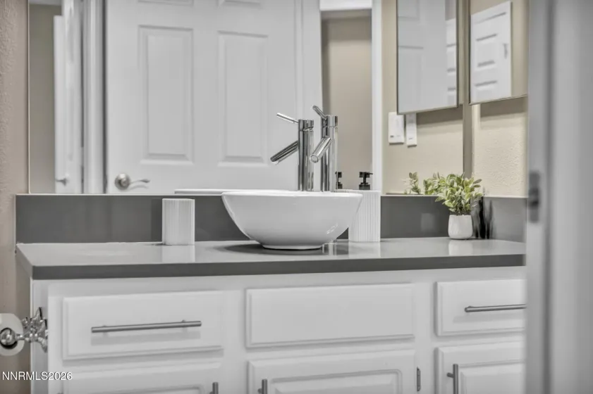 Second Bathroom – Close-up of the updated vanity, sink and modern faucet, showcasing stylish finishes and attention to detail.