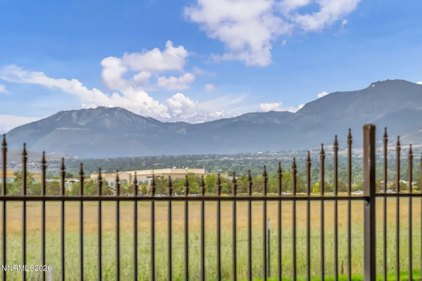Scenic Patio View – Relax and enjoy the peaceful patio setting with beautiful views overlooking a meadow and surrounding mountains.