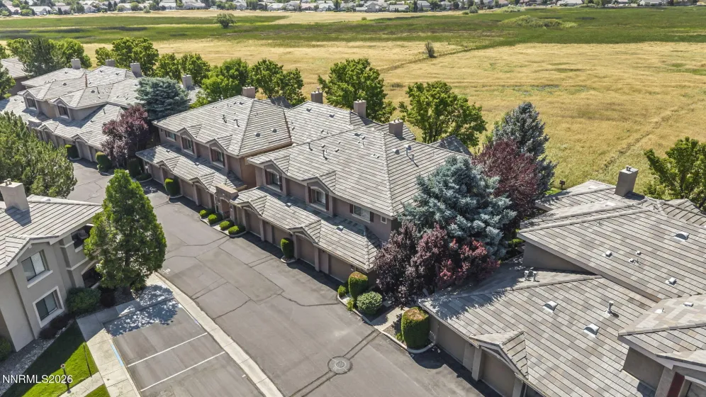 Aerial view of the front of the condo showcasing its prime location with open meadow views, highlighting the peaceful setting and scenic surroundings.