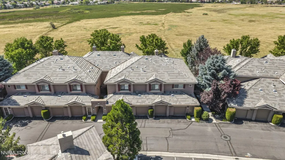 Aerial view of the front of the condo showcasing its prime location with open meadow views, highlighting the peaceful setting and scenic surroundings.