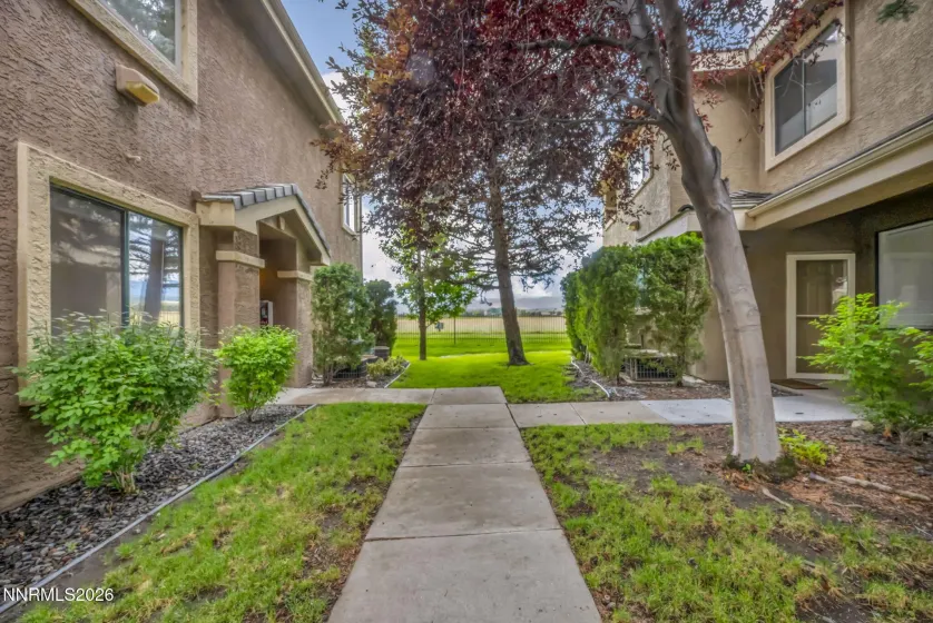 Front Walkway – Welcoming front walkway leading to the condo entrance, showcasing the attractive landscaping and easy access to the home.