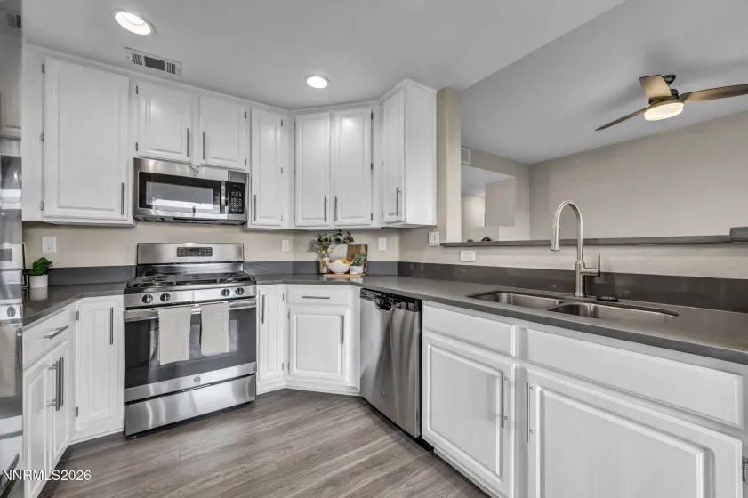 Kitchen – Well-appointed kitchen featuring ample cabinetry, generous counter space, stove, and sink, with a functional layout designed for everyday cooking and entertaining.