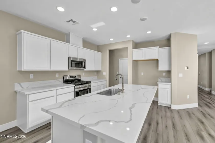 Quartz countertops, white cabinets