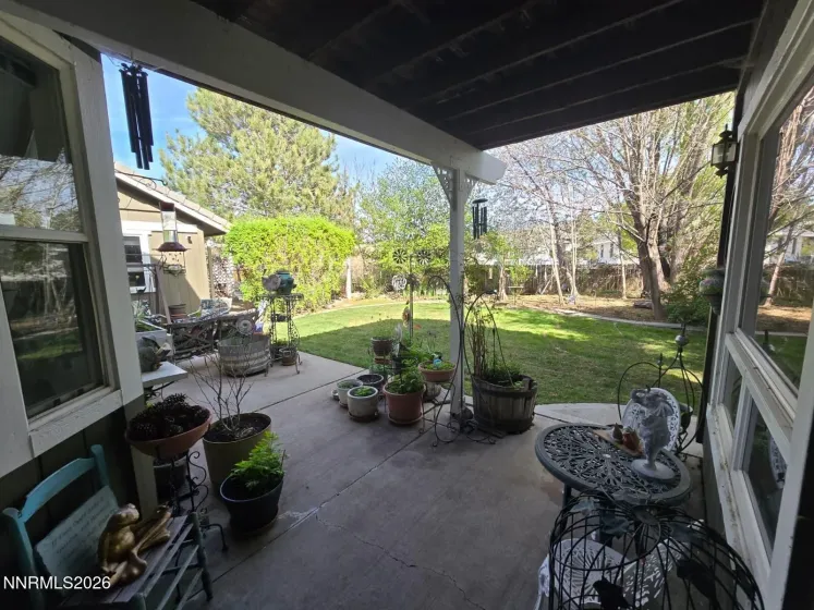 Covered porch area in backyard off of the sunroom
