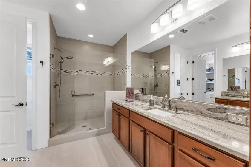 Upgraded granite, and shower accent tile.