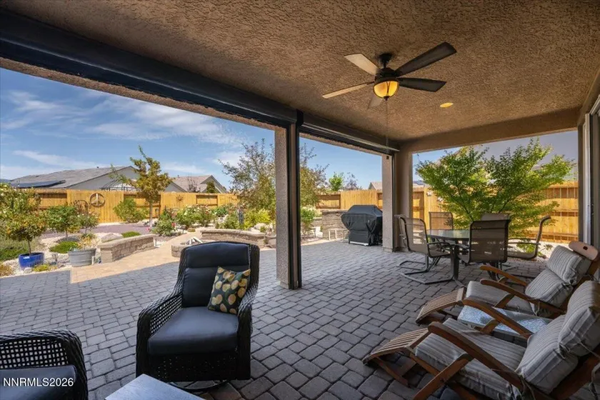Covered patio with ceiling to floor remote control shades.
