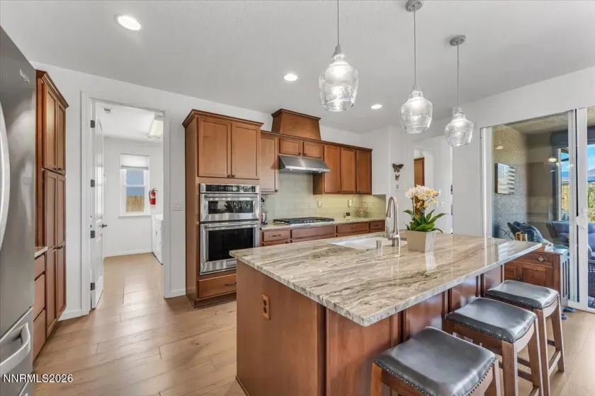 Upgraded granite and glass tile backsplash.