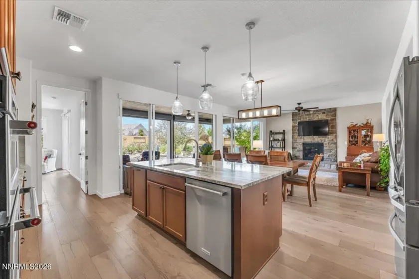 Designer pendant lighting over breakfast bar.
