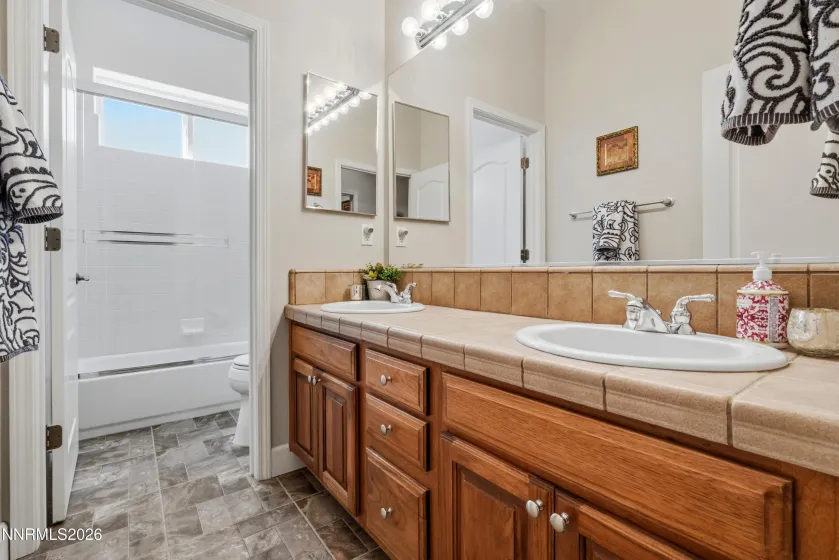 Hall bathroom double sinks and private water closet