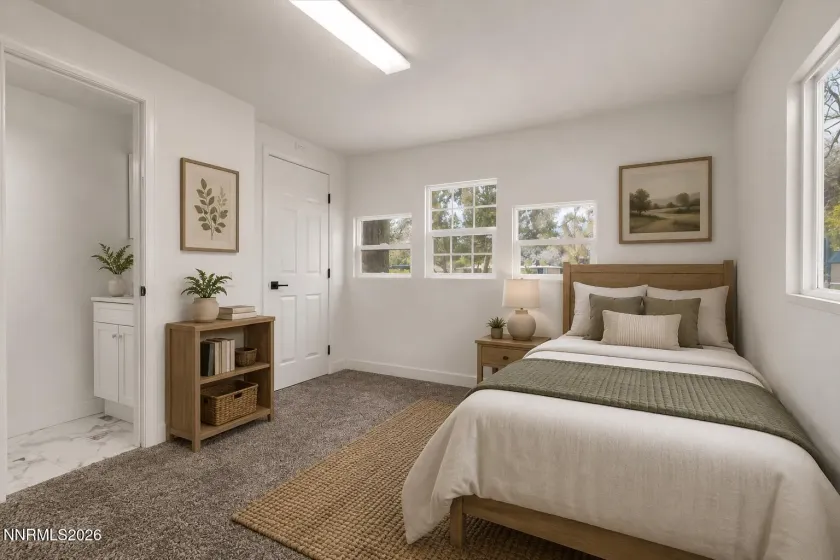 Virtually Staged bedroom 2 with half bath to show potential