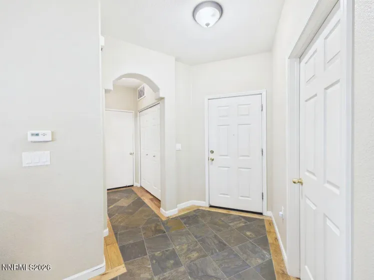 Front door and hallway to laundry closet and garage.