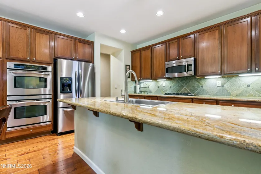 Enter into the open-concept kitchen and dining area, seamlessly connected to the spacious family room—an inviting space for everyday living and entertaining.