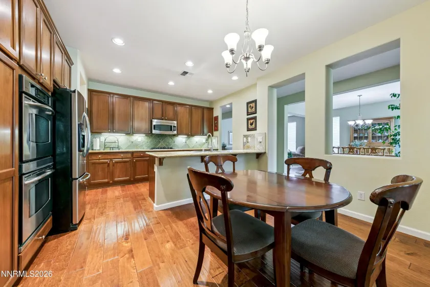 Enter into the open-concept kitchen and dining area, seamlessly connected to the spacious family room—an inviting space for everyday living and entertaining.
