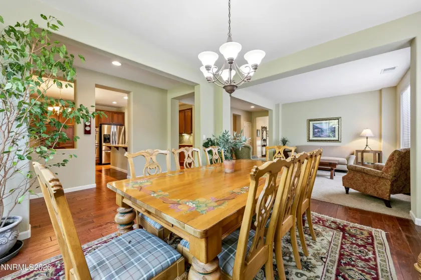 Light-filled formal dining area with abundant windows, creating a bright and inviting setting, conveniently adjacent to the elegant formal sitting/living room.