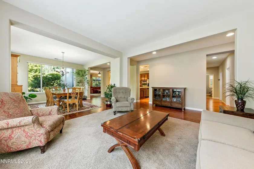 Light-filled formal sitting/living room with abundant natural light, thoughtfully positioned adjacent to the dining area—an inviting layout designed for gatherings and entertaining.