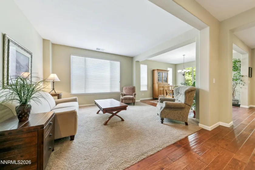 Light-filled formal sitting/living room with abundant natural light, thoughtfully positioned adjacent to the dining area—an inviting layout designed for gatherings and entertaining.