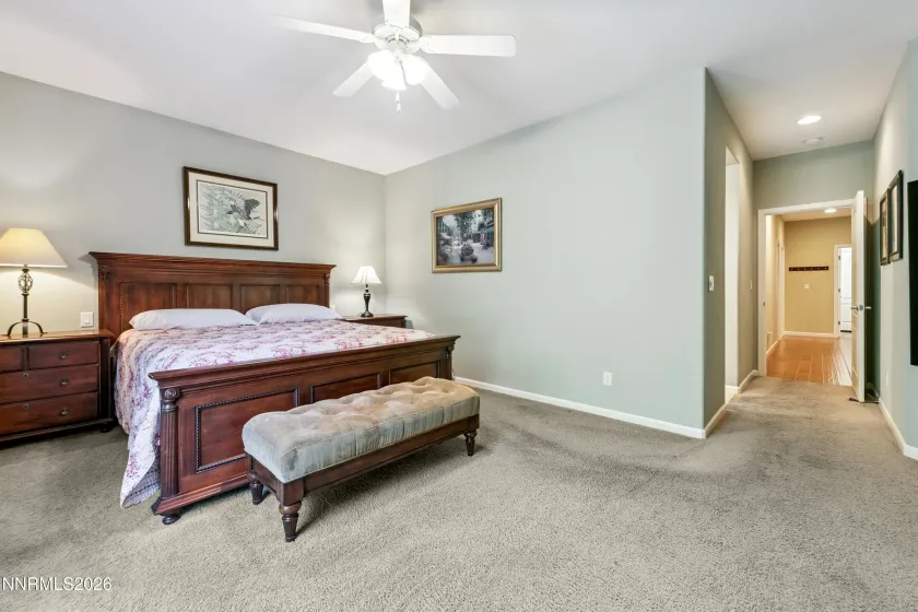 Spacious, light-filled primary bedroom with a sliding door providing direct access to the beautifully landscaped and serene backyard.