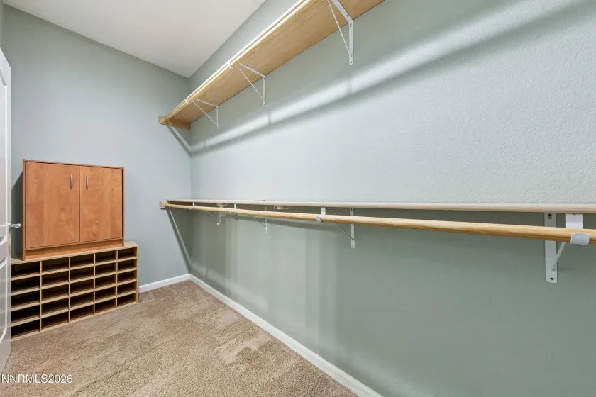 Spacious walk-in closet conveniently located off the spa-like primary bathroom, offering ample storage and easy access.