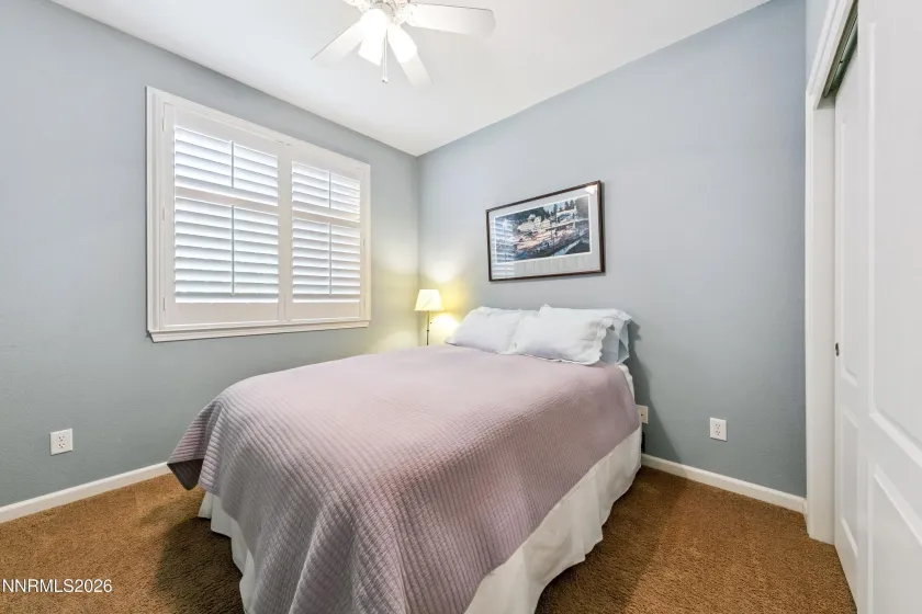 One of four bedrooms, offering comfortable accommodations and versatile living space.