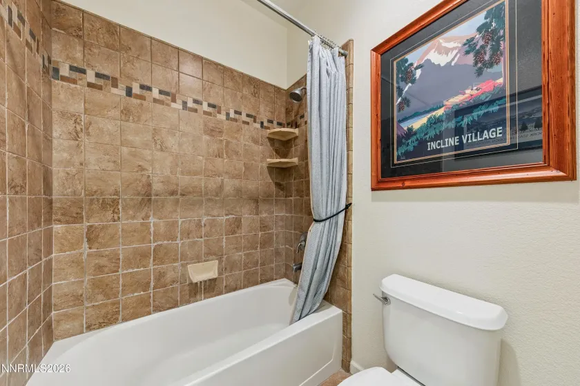 Spacious shared full bathroom serving two bedrooms, featuring a dual-sink vanity and a separate shower area for added privacy and functionality.