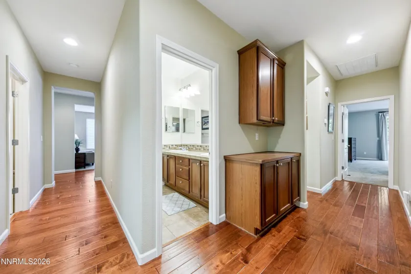 Convenient hallway connecting the bedrooms with one full bathroom and an additional half bath.