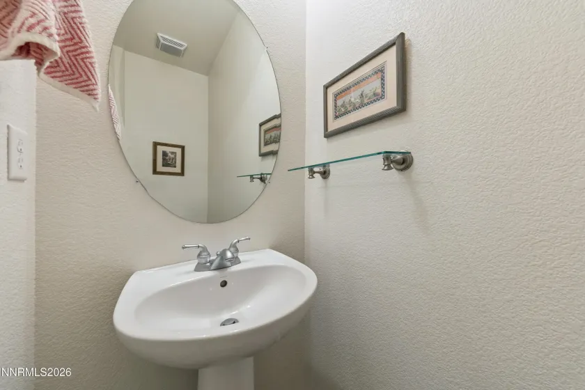 Convenient half bathroom located just off the entertaining area, ideal for guests.