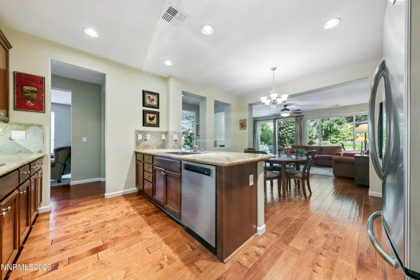 Enter into the open-concept kitchen and dining area, seamlessly connected to the spacious family room—an inviting space for everyday living and entertaining.
