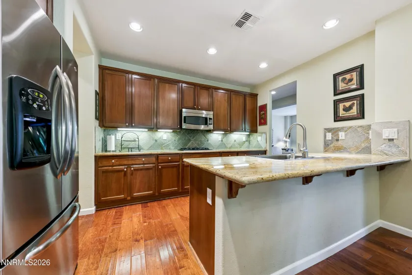 Enter into the open-concept kitchen and dining area, seamlessly connected to the spacious family room—an inviting space for everyday living and entertaining.