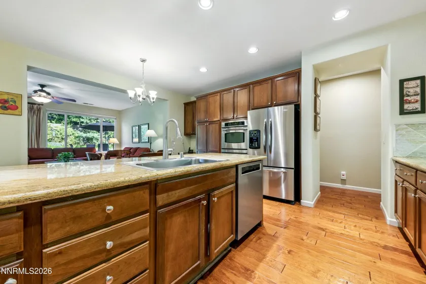 Enter into the open-concept kitchen and dining area, seamlessly connected to the spacious family room—an inviting space for everyday living and entertaining.