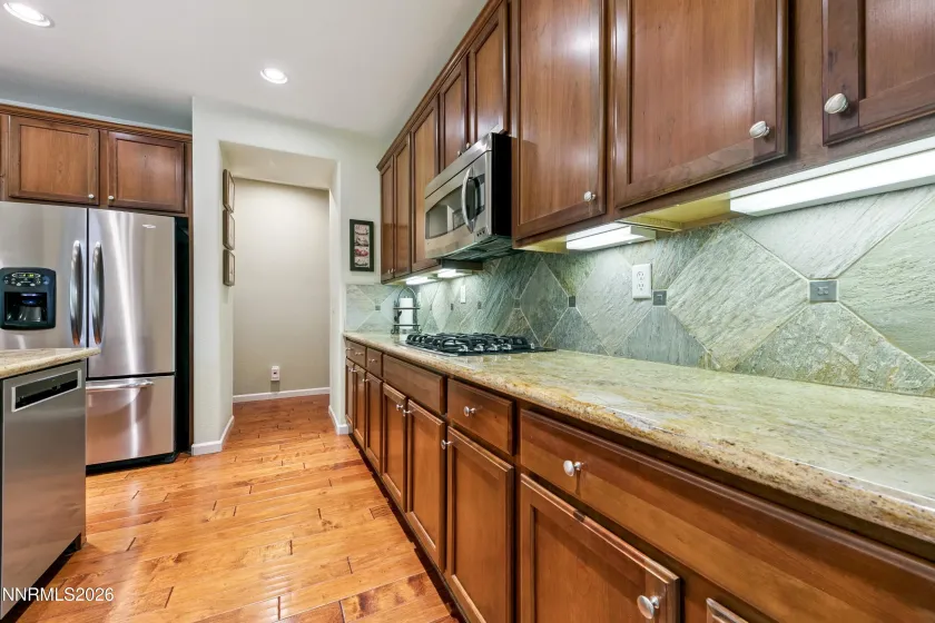 Enter into the open-concept kitchen and dining area, seamlessly connected to the spacious family room—an inviting space for everyday living and entertaining.