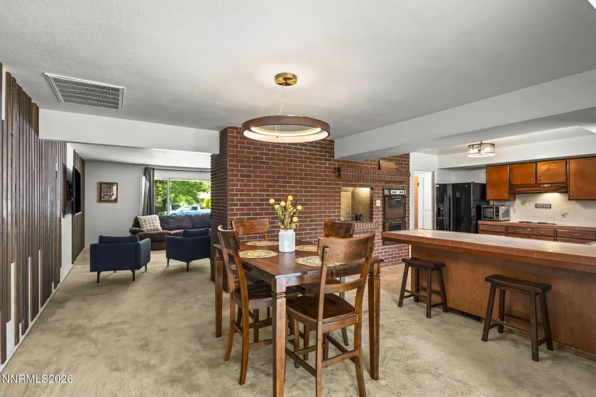 Shot from the bonus room showing the dining area, breakfast bar & kitchen.