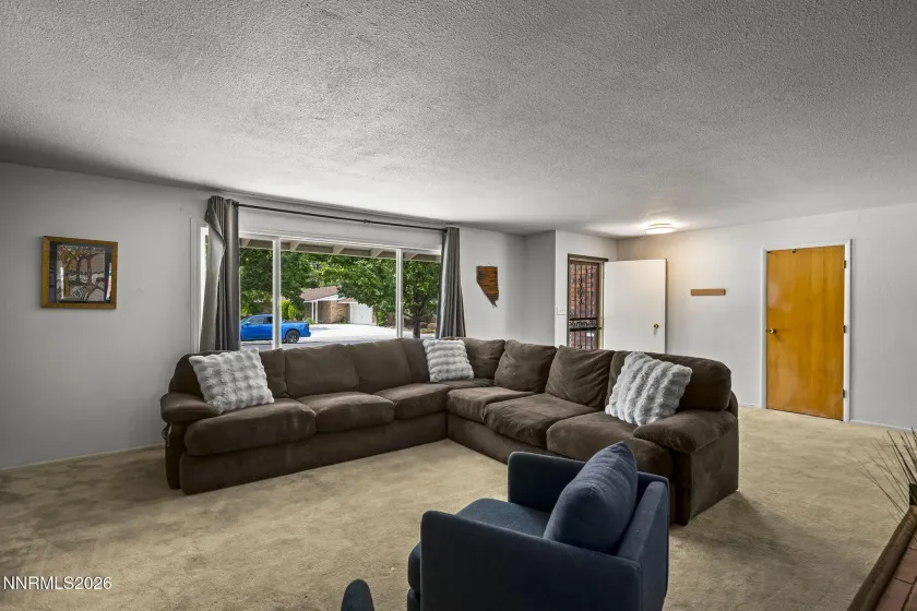 Living room, large window and coat closet.