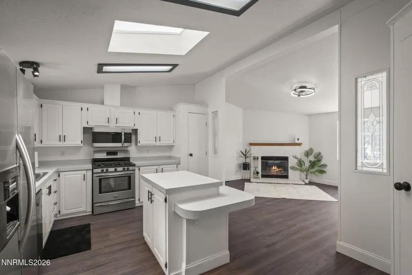 Kitchen with view of family room fireplace